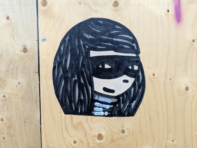 Small mural of a masked woman